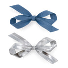 Light denim and silver bow clip set, each tied into a bow shape and casting a shadow on a white background.