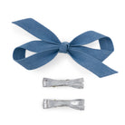 3-piece light denim and silver Bow Clip Set with one large denim bow and two smaller metallic silver bows, overhead view.