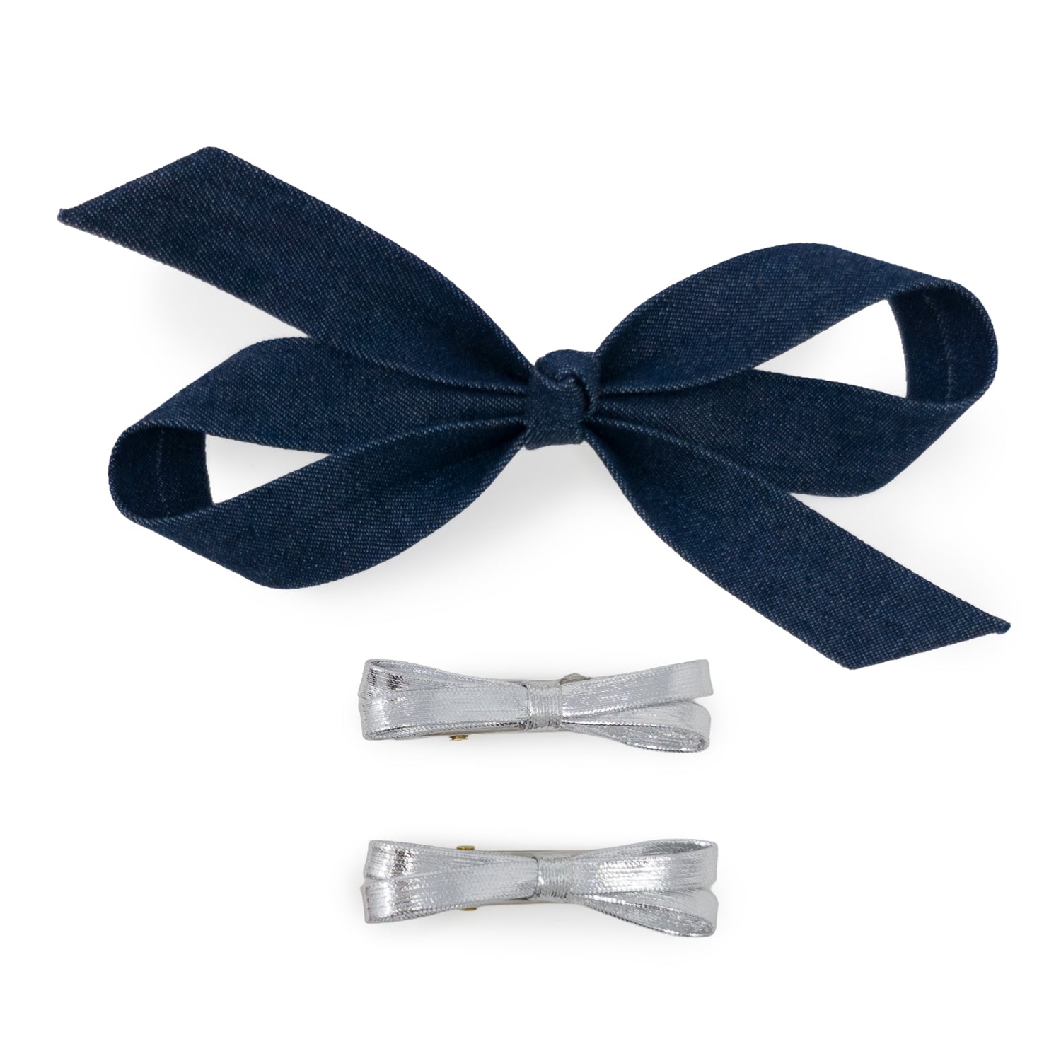 Bow Clip Set with one large dark blue denim bow and two small silver metallic bows, laid flat.