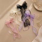 Sheer organza double ribbon clips in pink, white, black, and purple, featuring long wavy streamers.