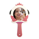Child holding up pink cartoon-shaped mirror.