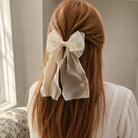 Sheer cream Organza Large Bow Clip on long reddish-brown hair, styled with a white textured shirt, seen from the back.