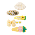 A set of six garden blossom hair clips with varied designs, including embroidered daisies, a sunflower, crochet, a yellow bow, and pearls.